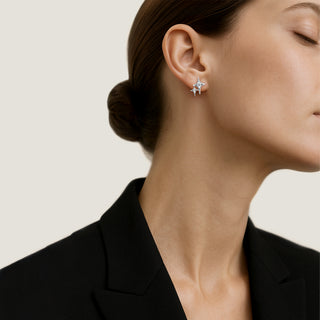 A pair of white gold earrings with round-cut white diamonds by Sybarite Jewellery.