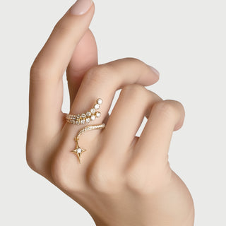 An 18K yellow gold ring with multiple round-cut white diamonds set in a unique celestial design, featuring a star motif.