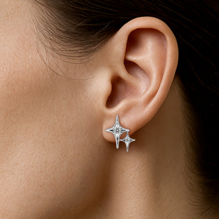 A pair of white gold earrings with round-cut white diamonds by Sybarite Jewellery.